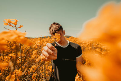 Man standing on field against sky