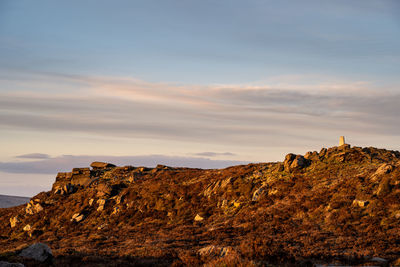 Scenic view of rock formations against sky during sunset