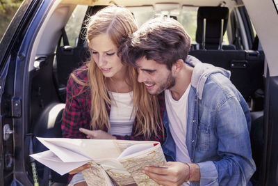 Portrait of smiling friends sitting in car