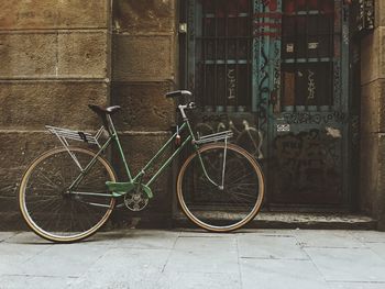 Side view of a bicycle against closed doors