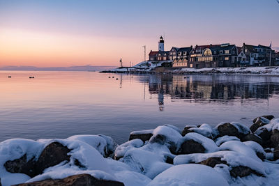 Scenic view of sea against buildings during winter