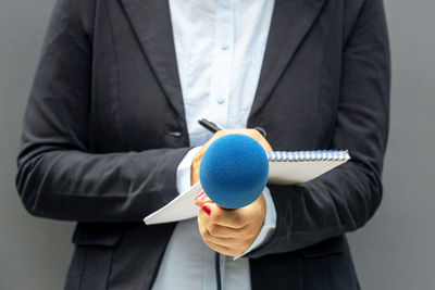 Midsection of man holding umbrella