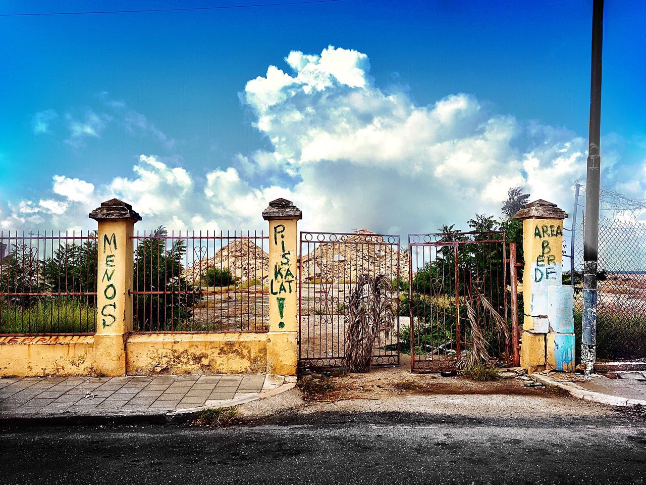 BUILT STRUCTURES AGAINST BLUE SKY AND CLOUDS