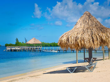 Palapa on beach agaist blue sky