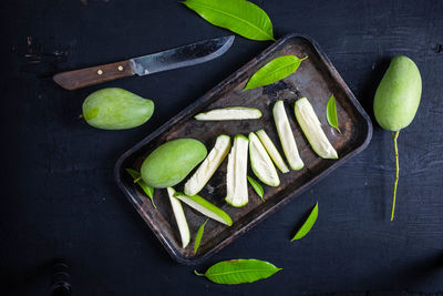 High angle view of fruits on table against black background