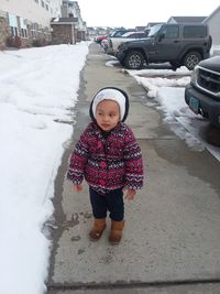 Cute girl standing in snow