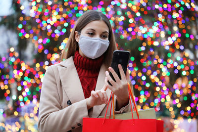 Portrait of young woman using mobile phone