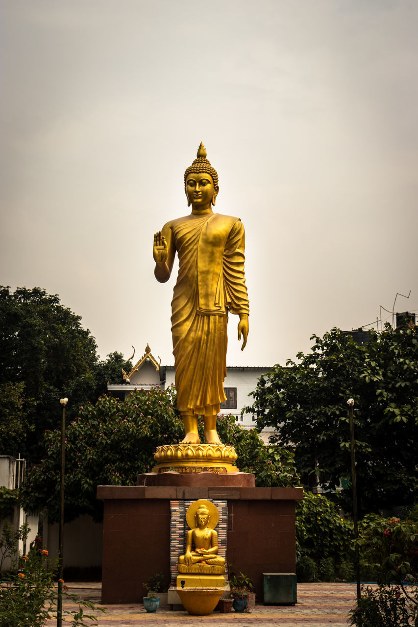 STATUE OF BUDDHA AGAINST TREES