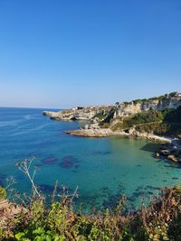 Scenic view of sea against clear blue sky