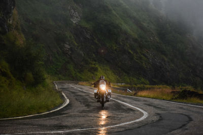 Man riding motorcycle on road