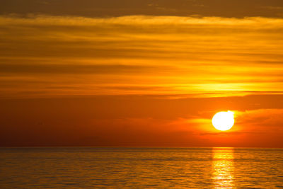 Scenic view of sea against orange sky