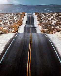 High angle view of empty road by sea