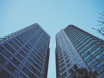 Low angle view of modern buildings against clear blue sky