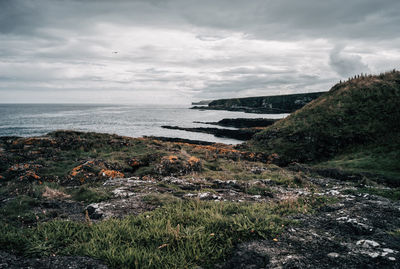 Scenic view of sea against cloudy sky