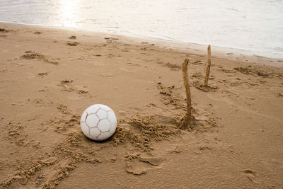 High angle view of soccer ball on beach