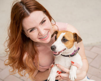 Portrait of young woman with dog