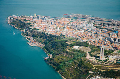 High angle view of city by sea against sky