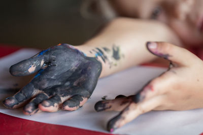 Close-up of little girl showing messy hands