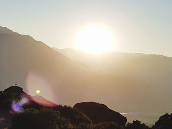 Scenic view of silhouette mountains against sky during sunset