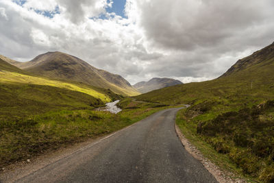 Road amidst mountains against sky