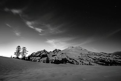 Scenic view of snow covered cascade range against sky at night