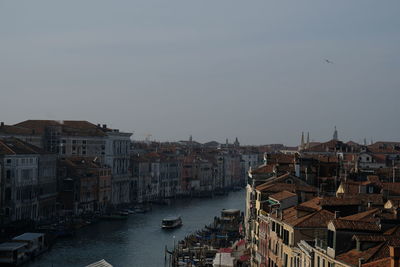 Buildings in city against clear sky