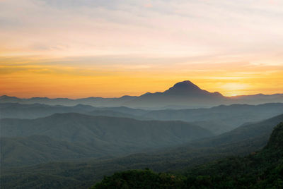 Scenic view of silhouette mountains against sky during sunset