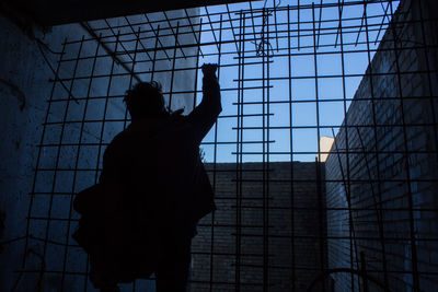 Silhouette man against the wall