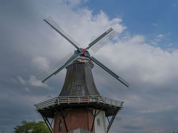 Low angle view of traditional windmill against sky