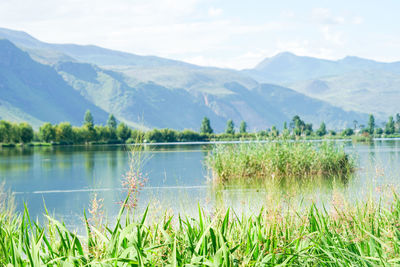 Scenic view of lake and mountains against sky