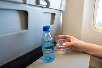 Cropped hand of woman holding bottle