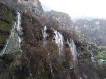 Scenic view of waterfall against sky