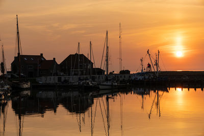 Sailboats in marina at sunset