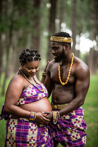 Midsection of couple standing outdoors