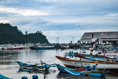 Boats moored in sea against sky