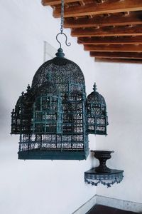 Low angle view of lantern hanging on building during winter