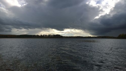 View of calm sea against cloudy sky