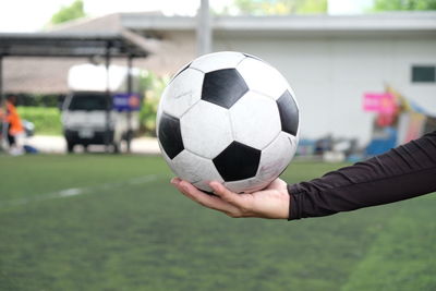 Cropped hand holding soccer ball