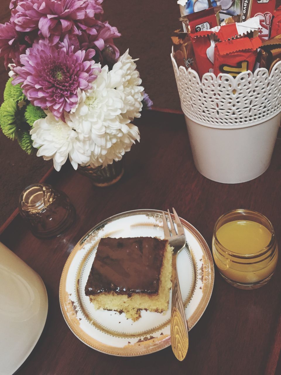 indoors, freshness, table, flower, food and drink, high angle view, food, plate, still life, vase, sweet food, decoration, no people, ready-to-eat, close-up, bowl, dessert, indulgence, potted plant, serving size