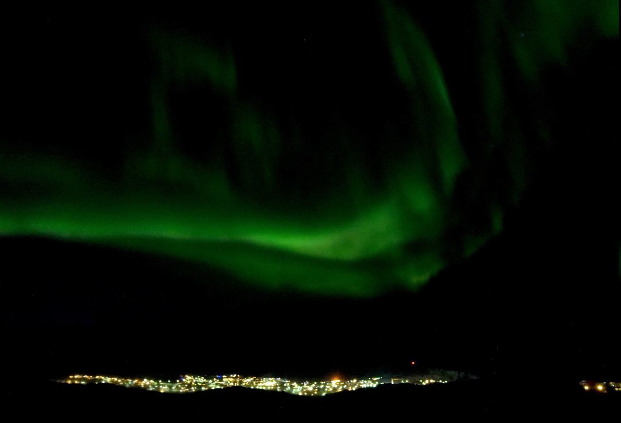 ILLUMINATED CITY AGAINST SKY AT NIGHT