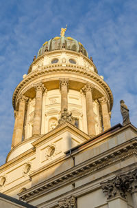 Low angle view of french cathedral against sky at gendarmenmarkt, berlin, germany