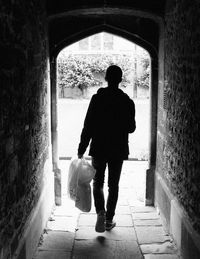 Full length of woman walking in tunnel