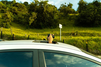 Man photographing from car