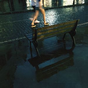 Low section of man walking in water