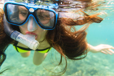 Close-up of woman snorkeling undersea