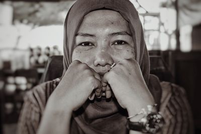 Close-up portrait of smiling woman in headscarf