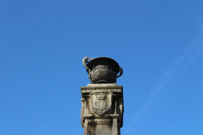 Low angle view of statue against clear blue sky