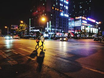 Illuminated city street at night