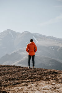 Rear view of man walking on mountain