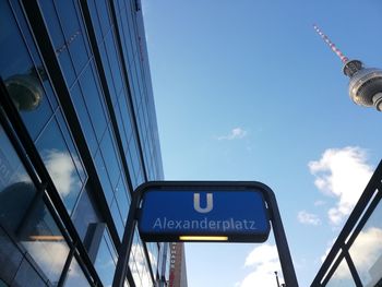 Low angle view of information sign against sky